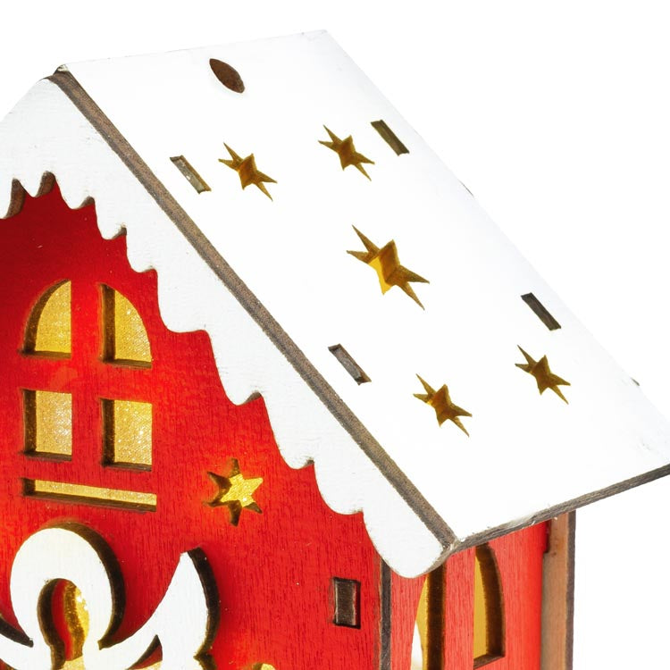 Rotes Adventshaus aus Holz mit Engel