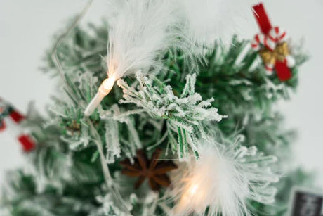 Ein kleiner, mit Schnee bedeckter Kiefern-Weihnachtsbaum