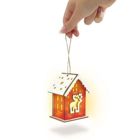 Rotes Adventshaus aus Holz mit Hirsch